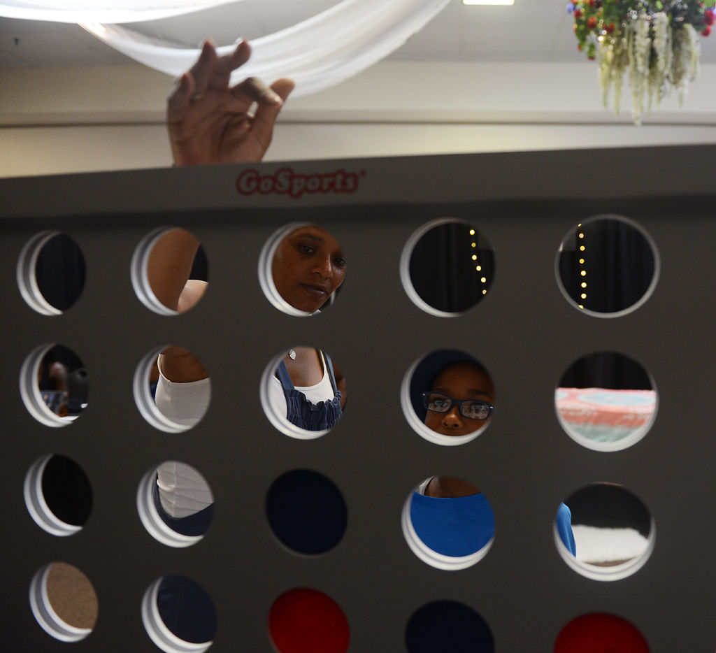 Naia and Armoni Owens, 8, play connect four